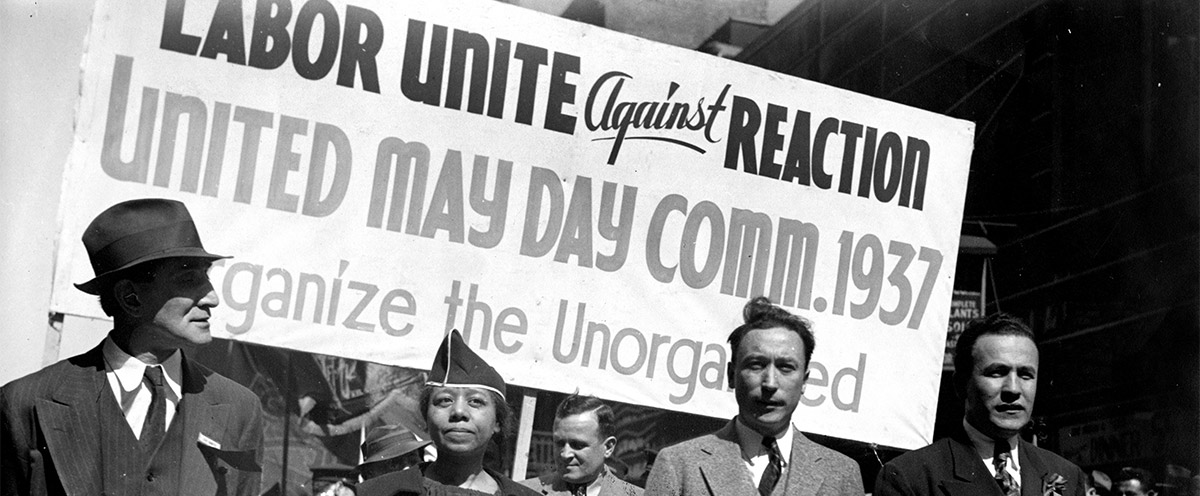 Edith Ransom and Charles Zimmerman (center) of ILGWU Local 22 march with others in the 1937 May Day parade.